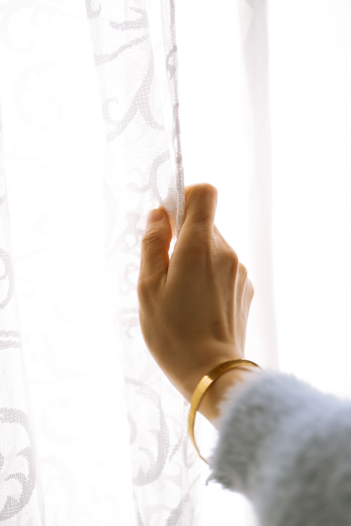 A hand resting near a window, wearing a simple wristband, standing in for the real CET copper wristband